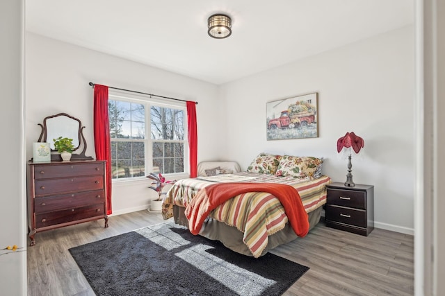 bedroom featuring wood finished floors and baseboards