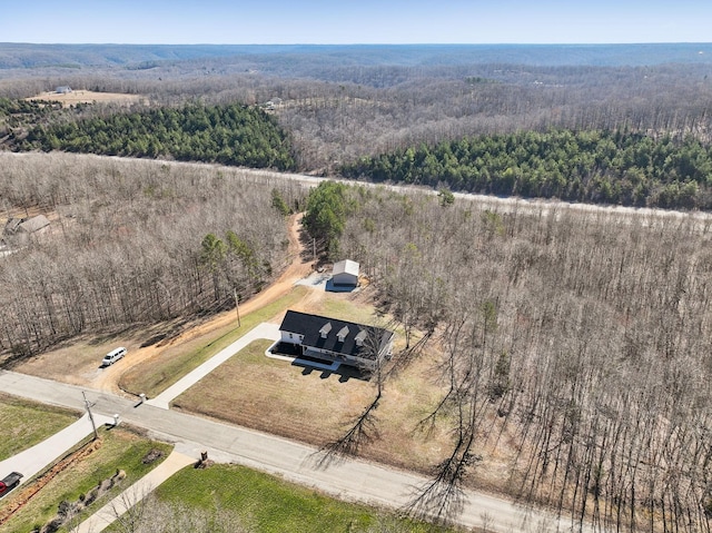 aerial view featuring a forest view and a rural view