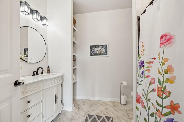 full bathroom with marble finish floor, a shower with curtain, baseboards, and vanity