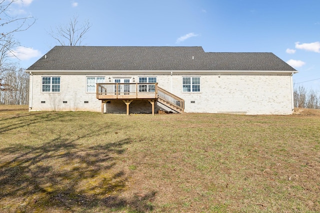 back of property with a yard, brick siding, crawl space, and a wooden deck