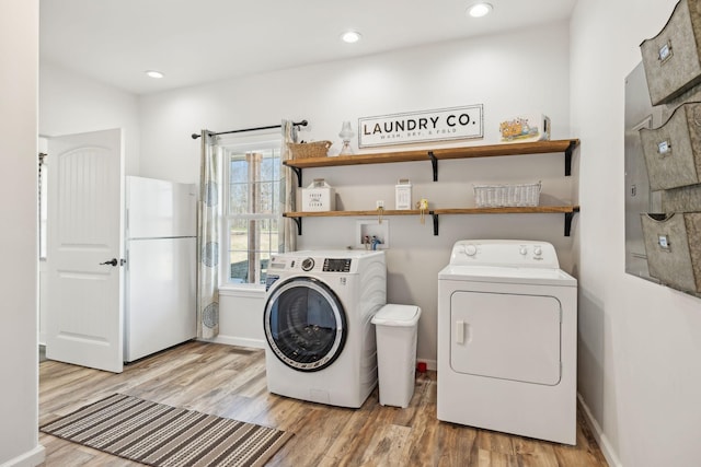 washroom with recessed lighting, laundry area, wood finished floors, baseboards, and independent washer and dryer