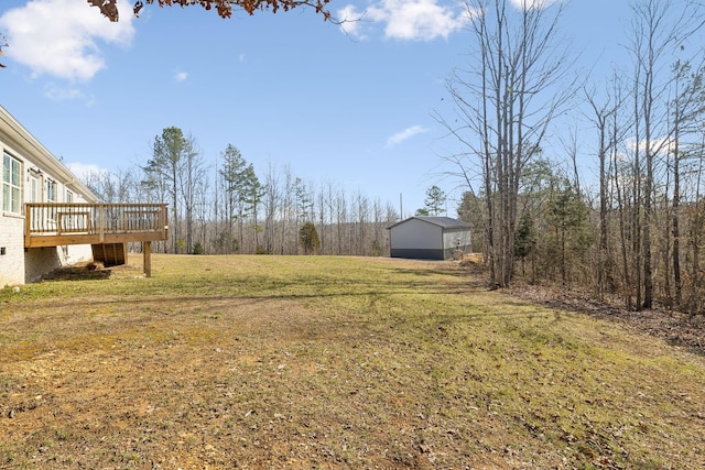 view of yard with an outdoor structure and a wooden deck