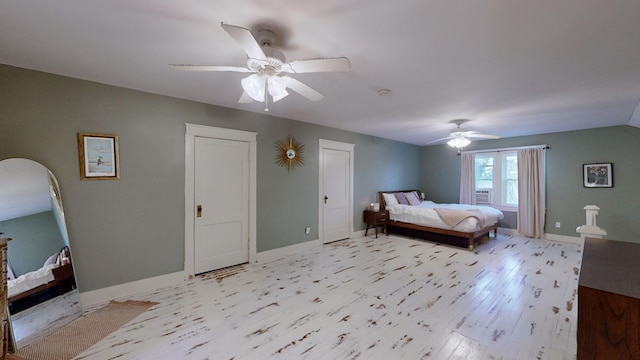 bedroom featuring light wood finished floors, ceiling fan, and baseboards