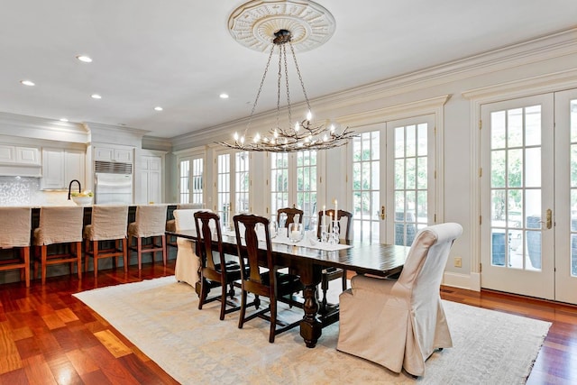 dining room featuring ornamental molding, french doors, and wood finished floors