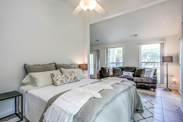 bedroom featuring light tile patterned floors, visible vents, baseboards, lofted ceiling, and ceiling fan