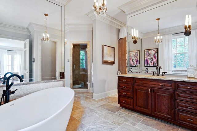 bathroom with ornamental molding, a wealth of natural light, and a notable chandelier