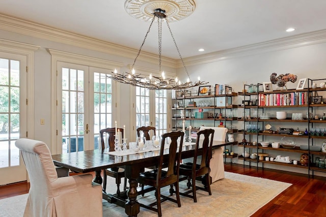 dining area with ornamental molding, wood finished floors, french doors, a notable chandelier, and recessed lighting