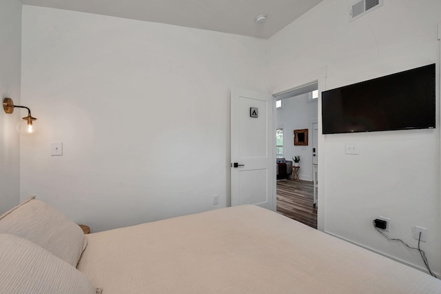 bedroom with visible vents and wood finished floors