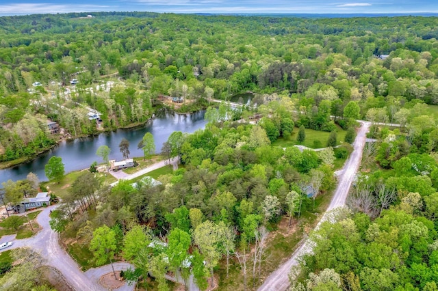 drone / aerial view with a water view and a wooded view