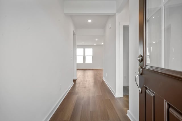 hallway with dark wood-style floors, recessed lighting, and baseboards