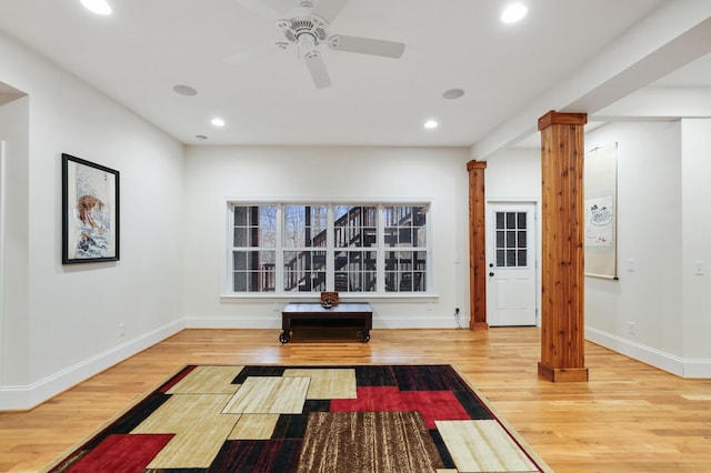 workout area featuring ornate columns, wood finished floors, and recessed lighting