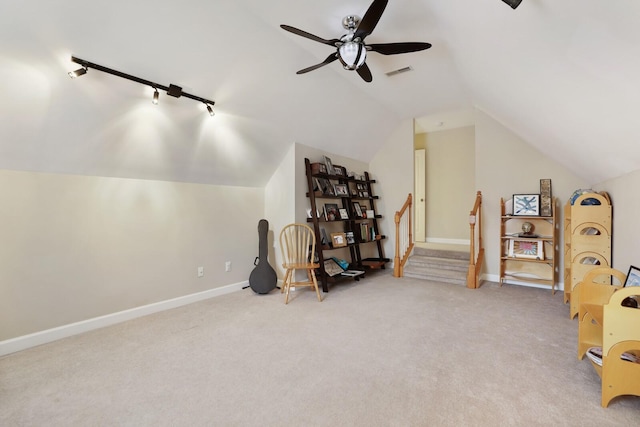 interior space featuring vaulted ceiling, carpet floors, visible vents, and baseboards