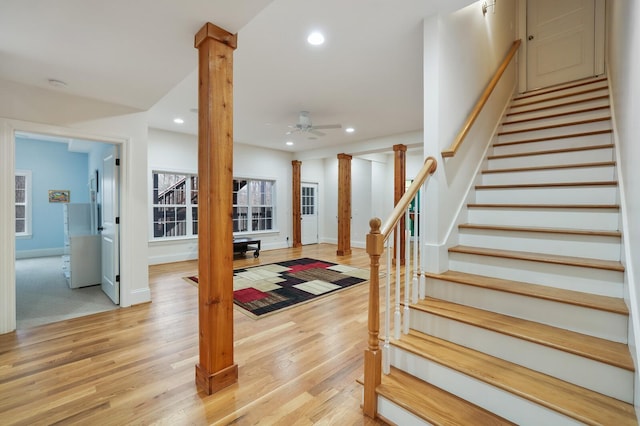 foyer featuring stairway, recessed lighting, light wood-style flooring, and ornate columns