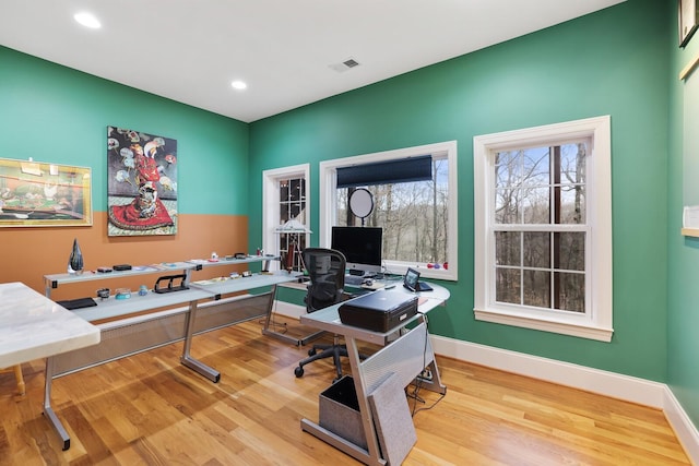 office space featuring baseboards, visible vents, wood finished floors, and recessed lighting