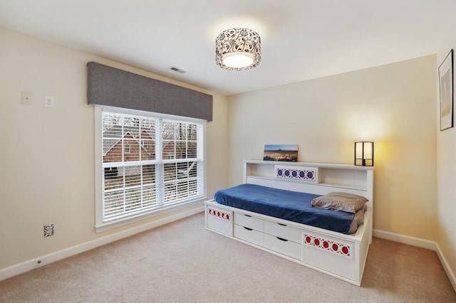 carpeted bedroom featuring visible vents and baseboards