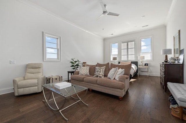 living room with dark wood-style floors, a ceiling fan, baseboards, and crown molding