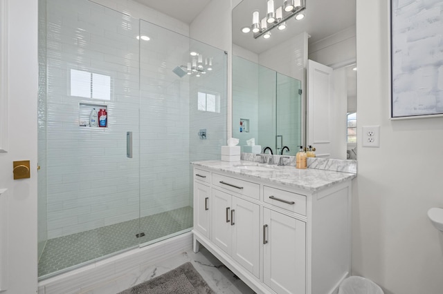 full bath featuring marble finish floor, vanity, and a stall shower