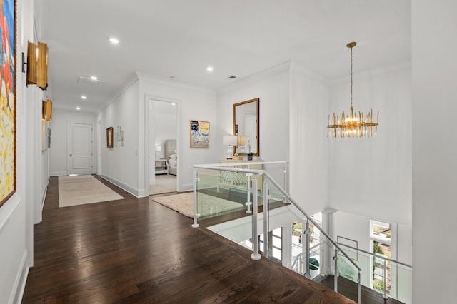 hallway featuring ornamental molding, wood finished floors, an inviting chandelier, an upstairs landing, and recessed lighting