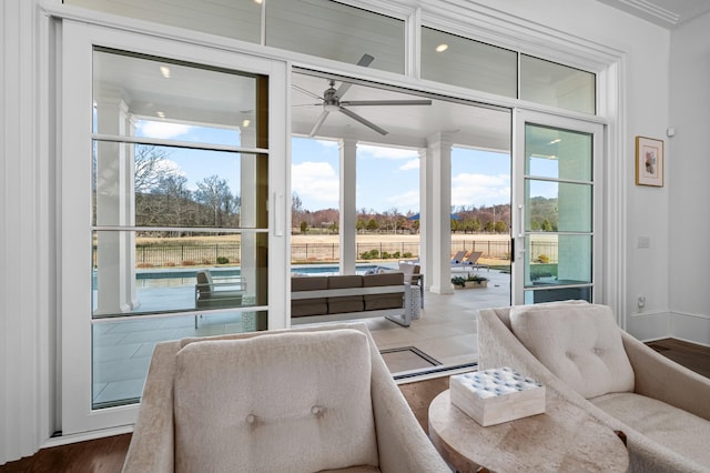 interior space featuring dark wood-style flooring, a ceiling fan, and baseboards