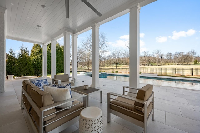 view of patio with an outdoor hangout area, fence, and a fenced in pool