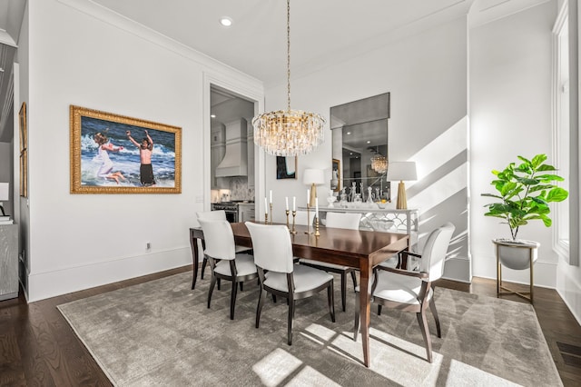 dining space featuring a chandelier, recessed lighting, wood finished floors, baseboards, and ornamental molding