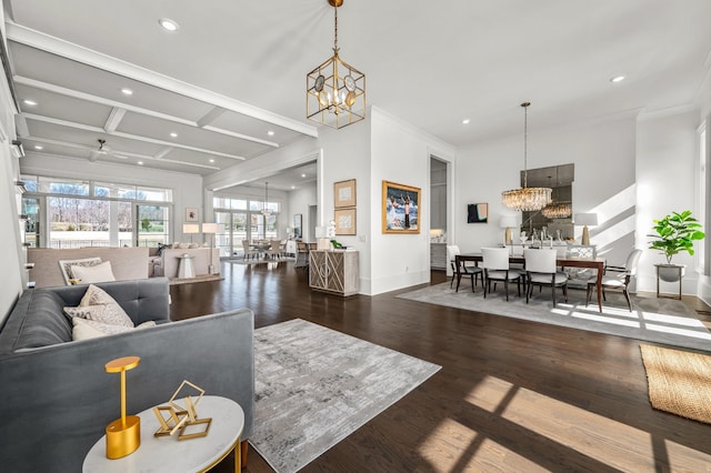 living room with baseboards, ornamental molding, dark wood-type flooring, a chandelier, and recessed lighting