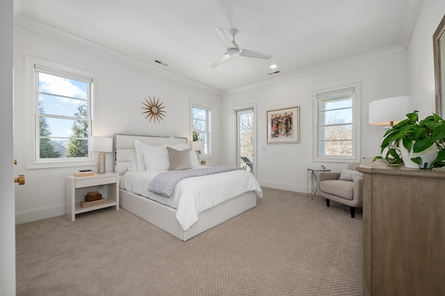 bedroom featuring baseboards, ceiling fan, multiple windows, and light colored carpet