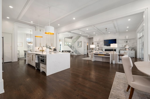 kitchen with dark wood-style floors, light countertops, a fireplace, and white cabinetry