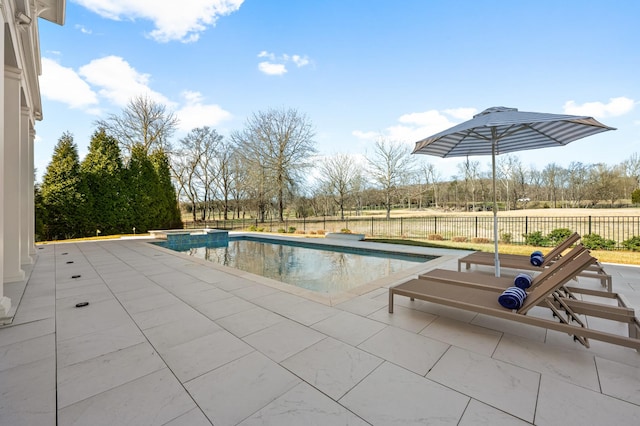 view of pool featuring a pool with connected hot tub, a patio area, and fence