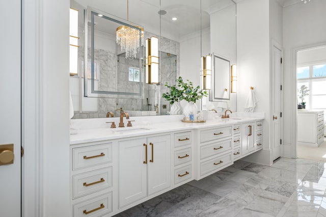 bathroom with marble finish floor, double vanity, recessed lighting, a sink, and a shower stall