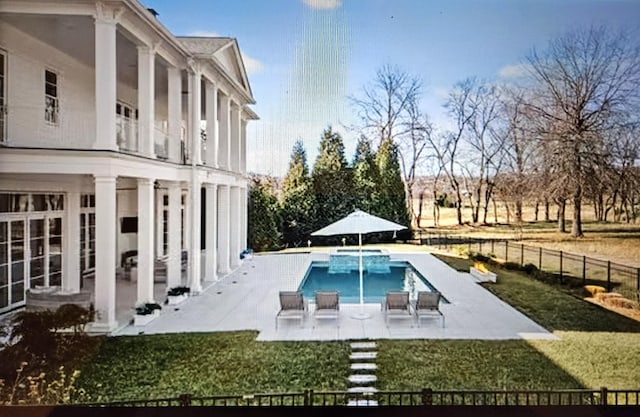 view of swimming pool featuring a lawn, a patio area, fence, and a fenced in pool