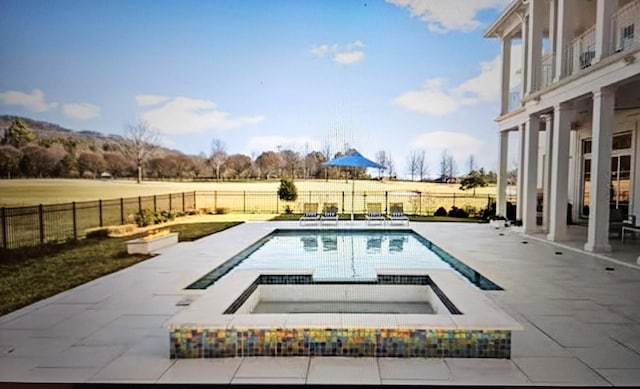 view of swimming pool with a fenced in pool, a fenced backyard, a patio, and an in ground hot tub