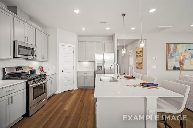 kitchen with gray cabinets, visible vents, stainless steel appliances, and a sink