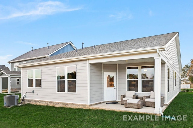 back of property featuring central AC unit, an outdoor hangout area, roof with shingles, a yard, and a patio area