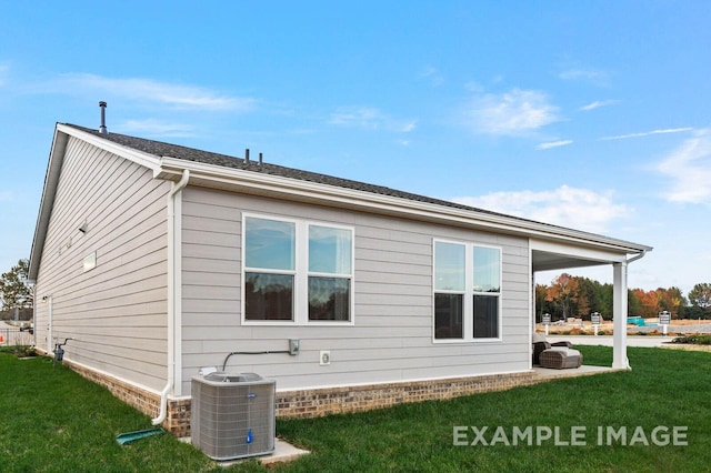 view of property exterior featuring central AC and a yard