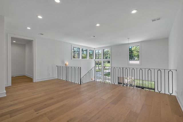 unfurnished room with visible vents, recessed lighting, a wealth of natural light, and light wood-style floors