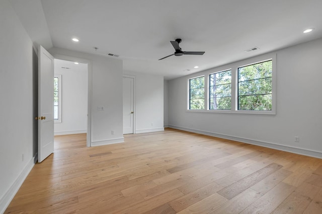 empty room with light wood-type flooring and visible vents