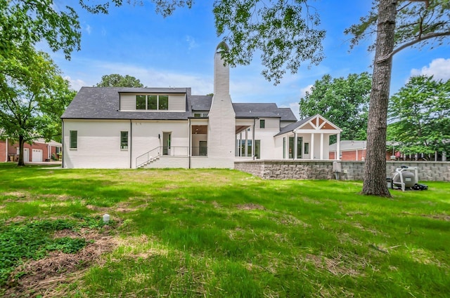 back of house featuring a lawn