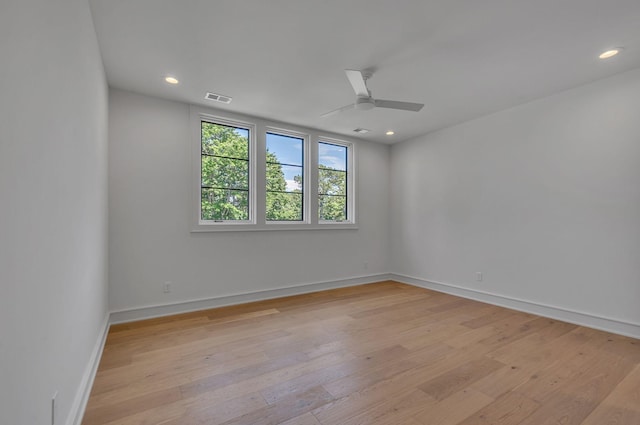 spare room with light wood-style flooring, recessed lighting, a ceiling fan, baseboards, and visible vents