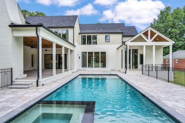 view of swimming pool with ceiling fan, a patio, an in ground hot tub, fence, and a fenced in pool