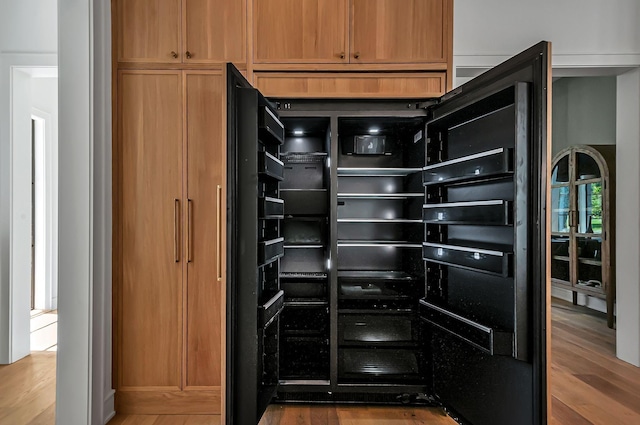 kitchen with wine cooler and wood finished floors