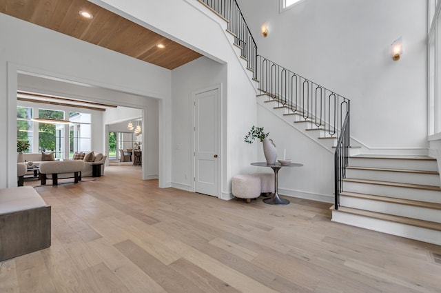 stairs with wooden ceiling, baseboards, wood finished floors, and recessed lighting