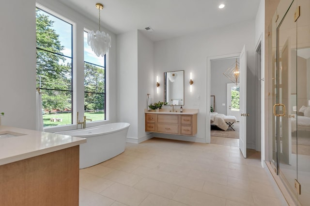 bathroom featuring a stall shower, visible vents, ensuite bath, an inviting chandelier, and vanity