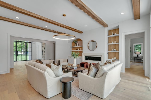 living room with built in features, light wood-style flooring, a fireplace, beam ceiling, and recessed lighting