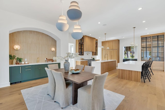 dining area with light wood-style floors and recessed lighting