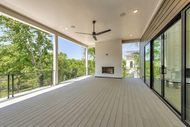 wooden deck with a ceiling fan