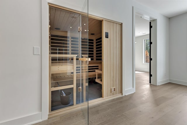 view of sauna / steam room featuring wood finished floors and baseboards