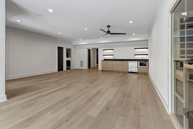 unfurnished living room with baseboards, light wood finished floors, a ceiling fan, and recessed lighting