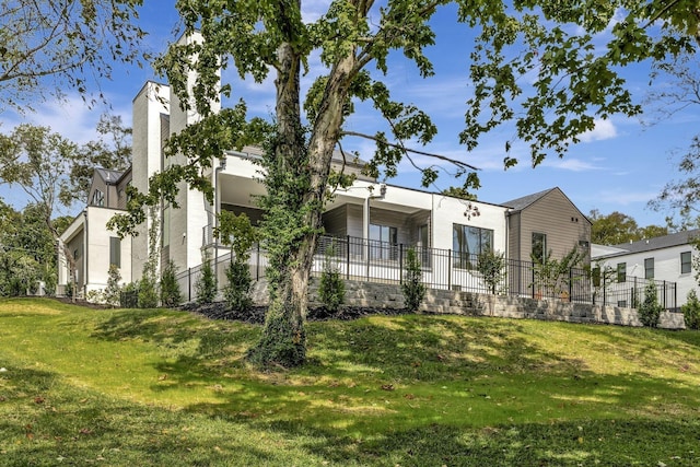 exterior space featuring fence and a front lawn