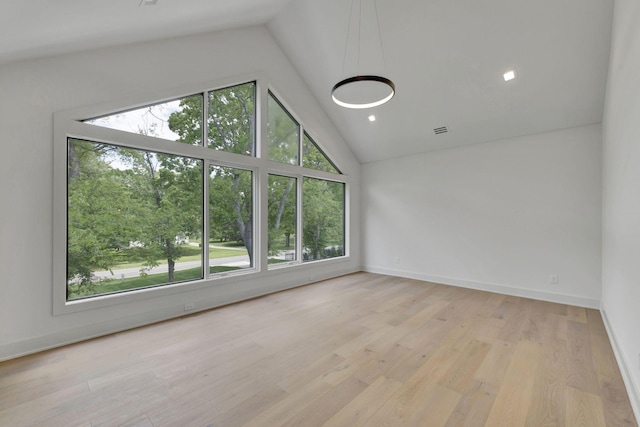 unfurnished room featuring high vaulted ceiling, recessed lighting, wood finished floors, visible vents, and baseboards